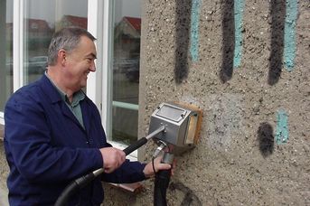 graffiti removal on roughcast