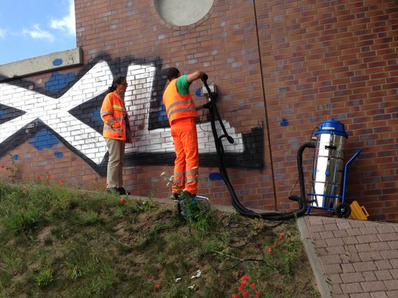 removing graffiti professional at a motorway