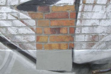 graffiti removal on brick with cleaning machine
